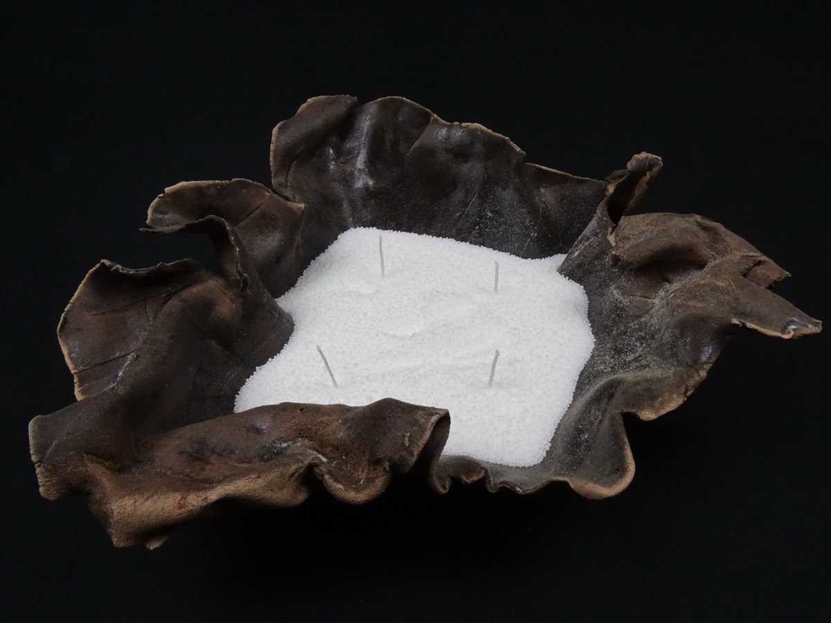 Große dunkelbraune Schale mit Kerzensand und Dreidocht